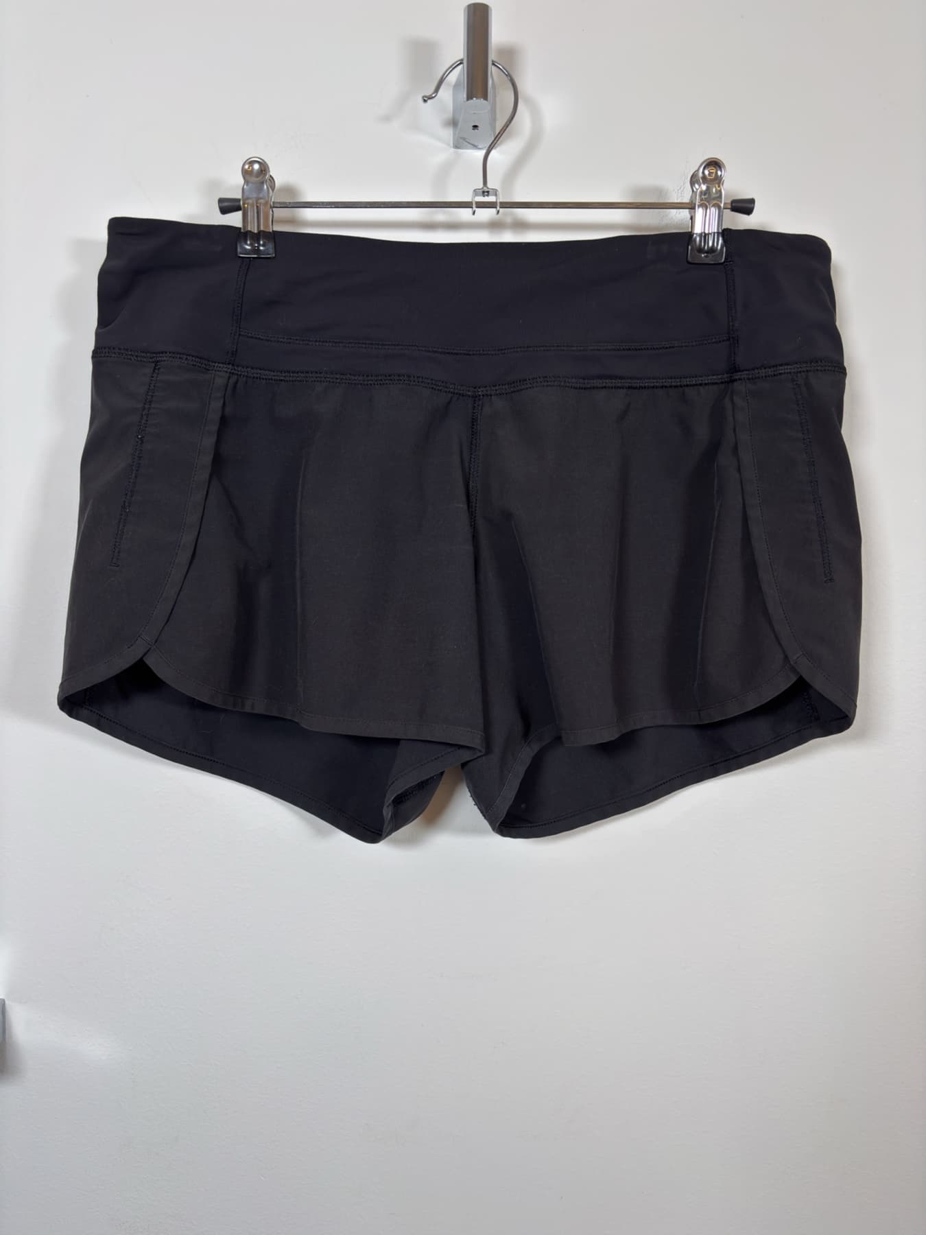 Front view of black Lululemon Speed Up shorts on a hanger.