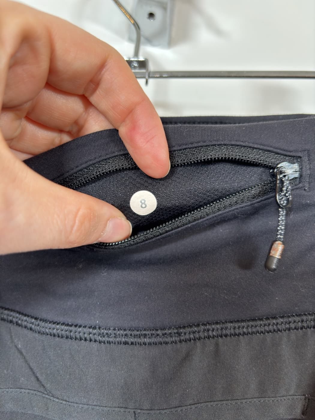 Close-up of the Lululemon size dot showing size 8.